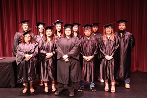 2025 GED Graduates in their caps and gowns on stage