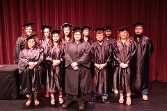 2025 GED Graduates in their caps and gowns on stage