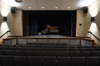 A concert piano on the interior stage of Johnson Symposium