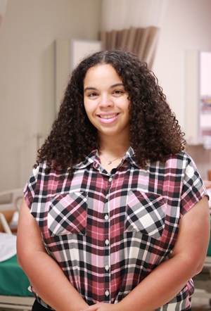 Dr Shenell Wood smiles in a classroom clinic at Victoria College