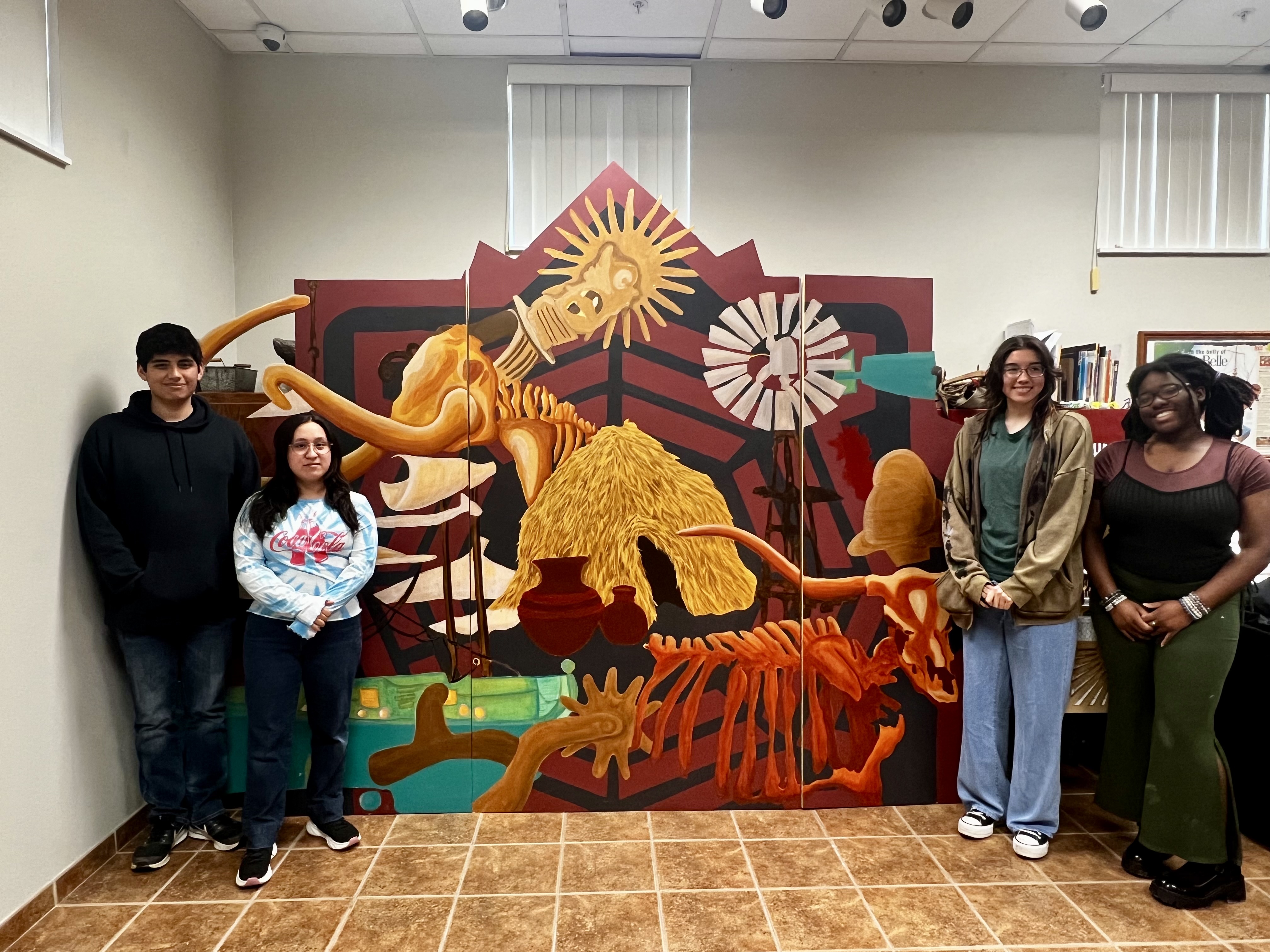 Four VC students stand by the mural they helped create