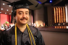 Graduating student in his cap and gown