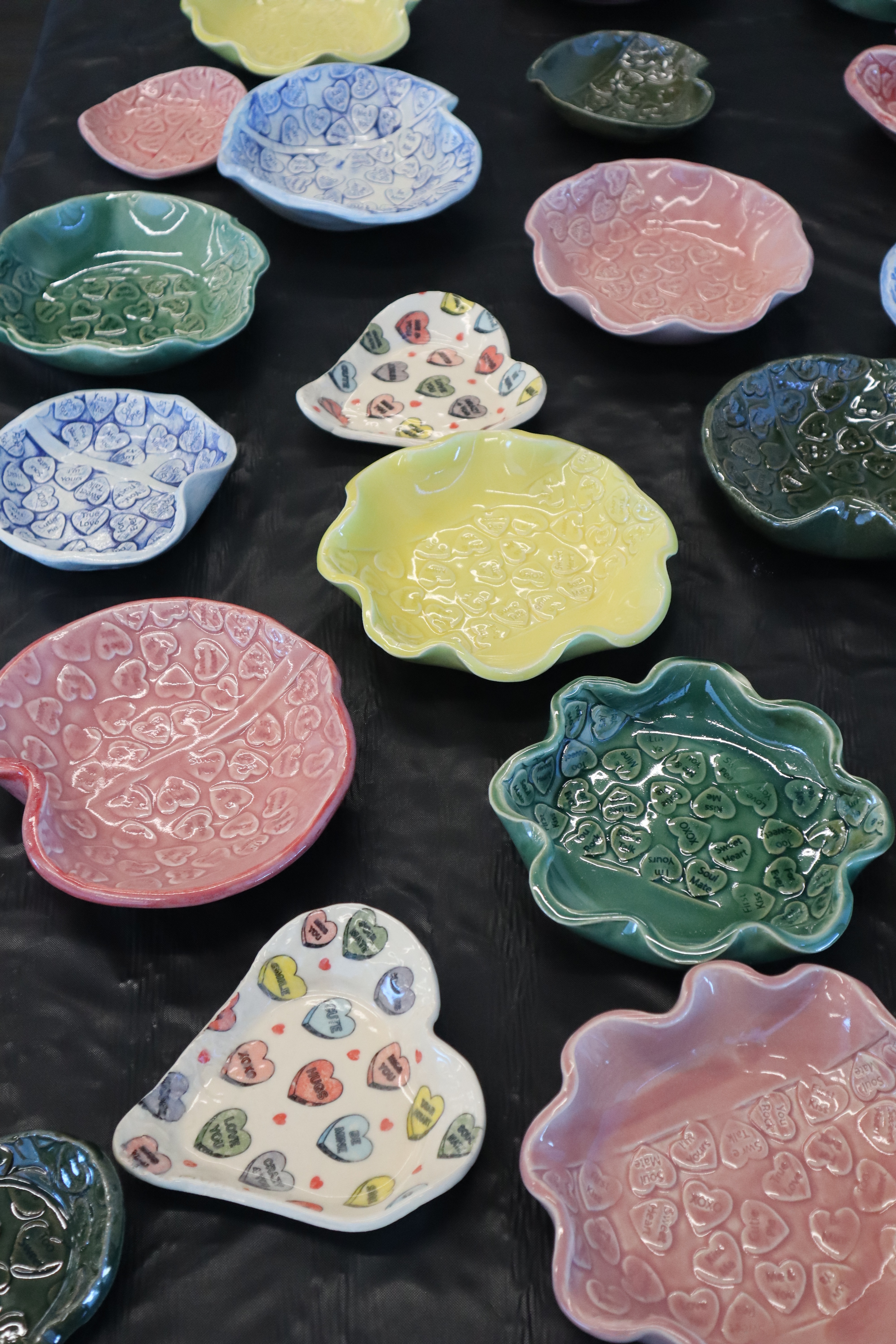 Heart shaped colorful bowls for purchase at empty bowls