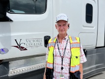 Rocky Pullin stands beside a VC truck